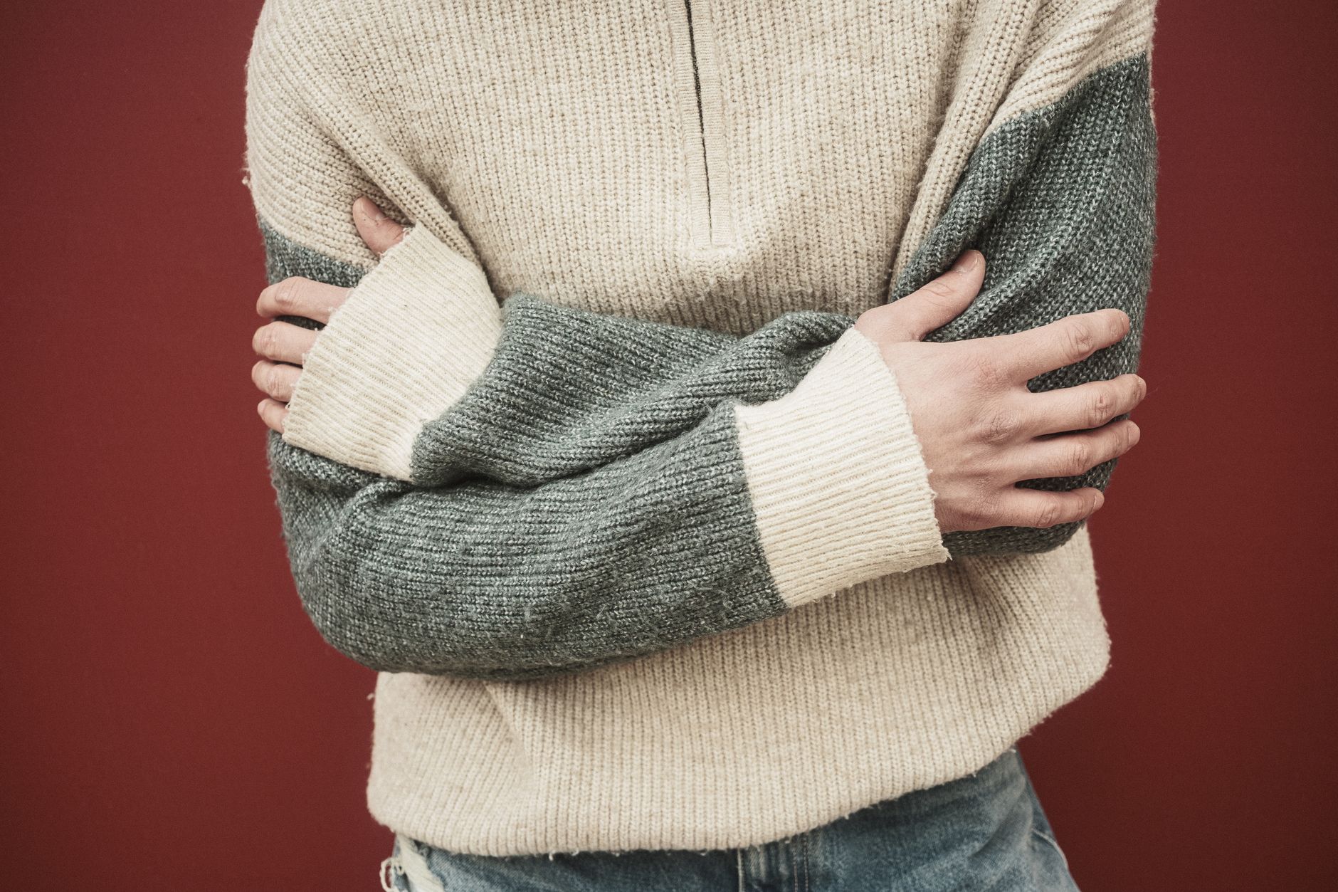Structured knit arm warmers in earthy tones worn over a minimalist outfit