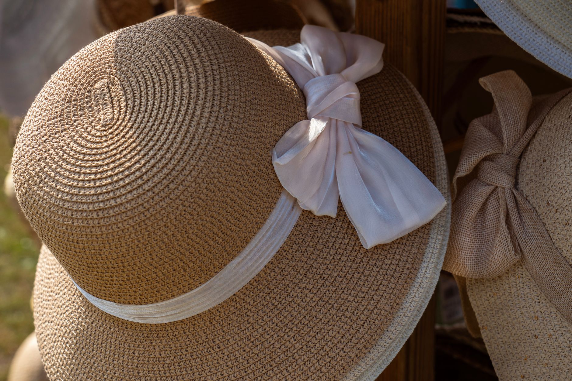 Person wearing a structured straw hat styled with summer fashion separates