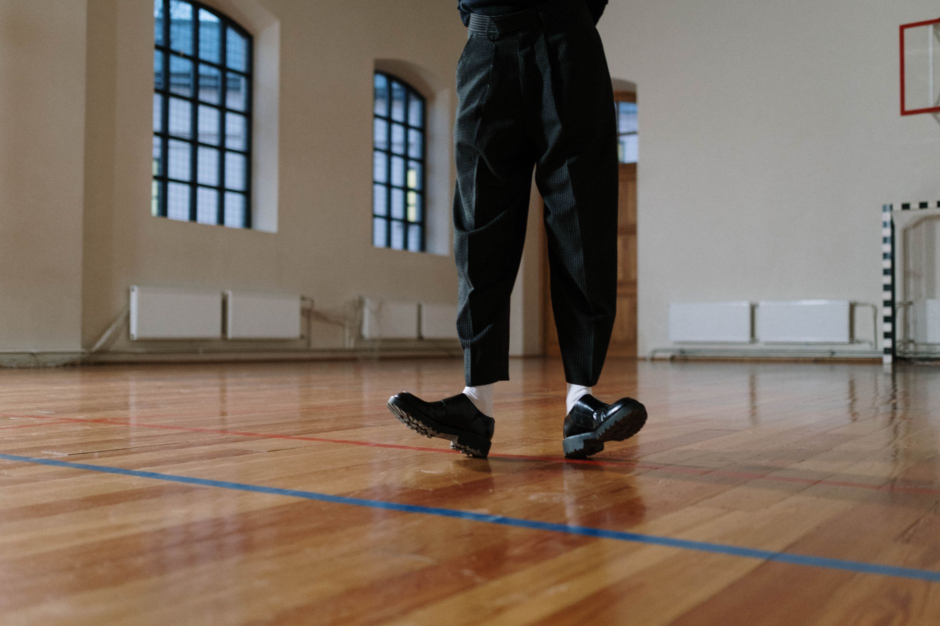 Close-up of trouser leg with visible strap and hardware detailing