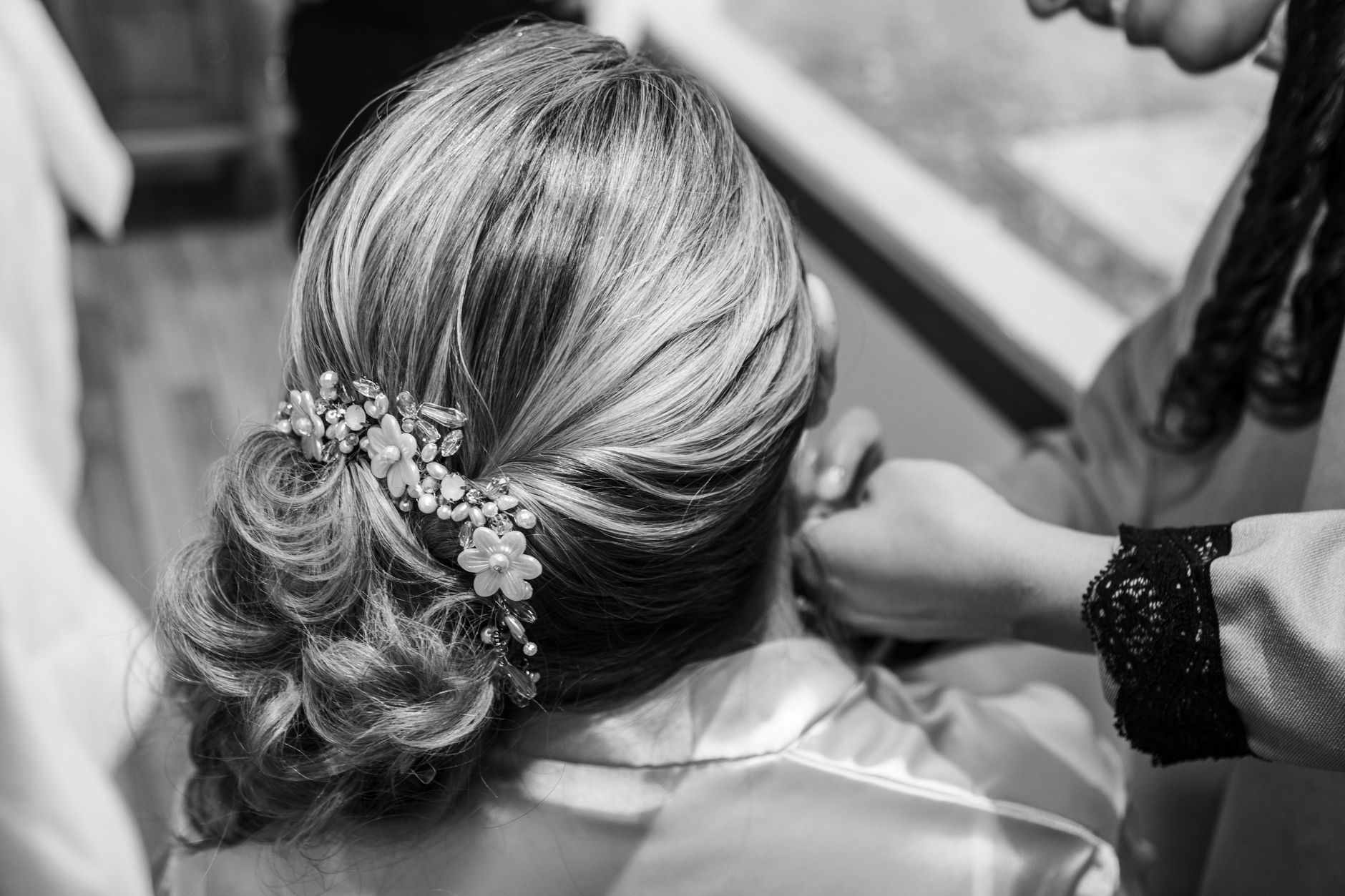 Woman with a low ponytail styled with a delicate net hair accessory at a formal event