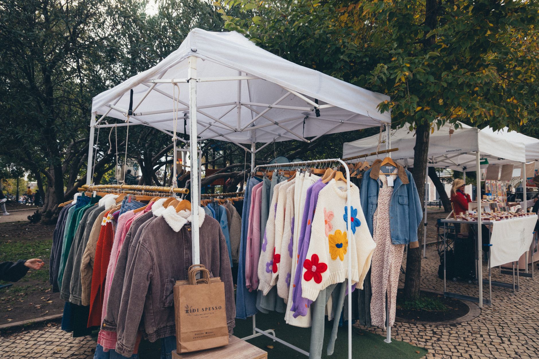 A rack of vintage structured jackets in bold stripe patterns at a secondhand clothing store
