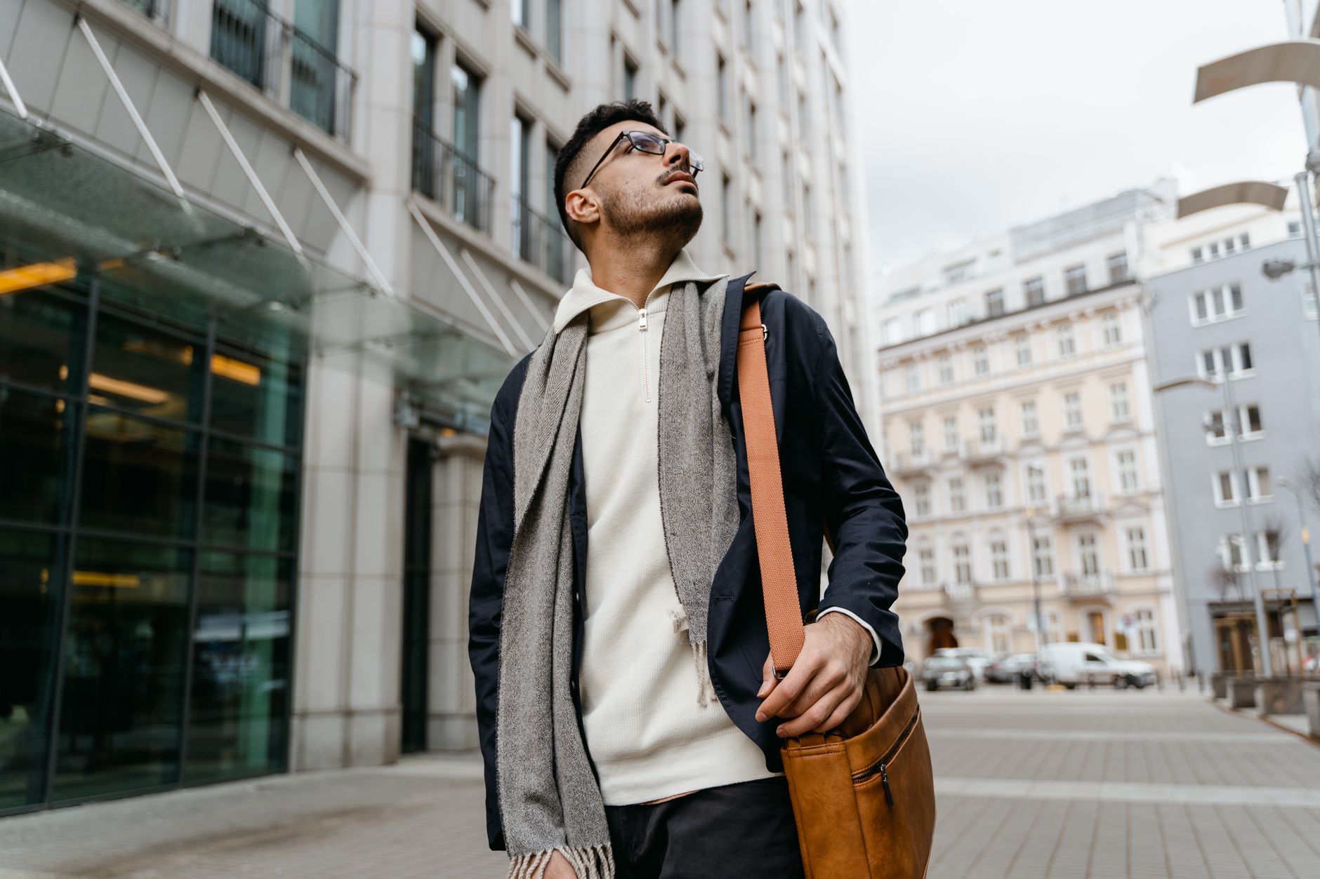 Male model wearing a layered padded vest over a base layer in an urban setting