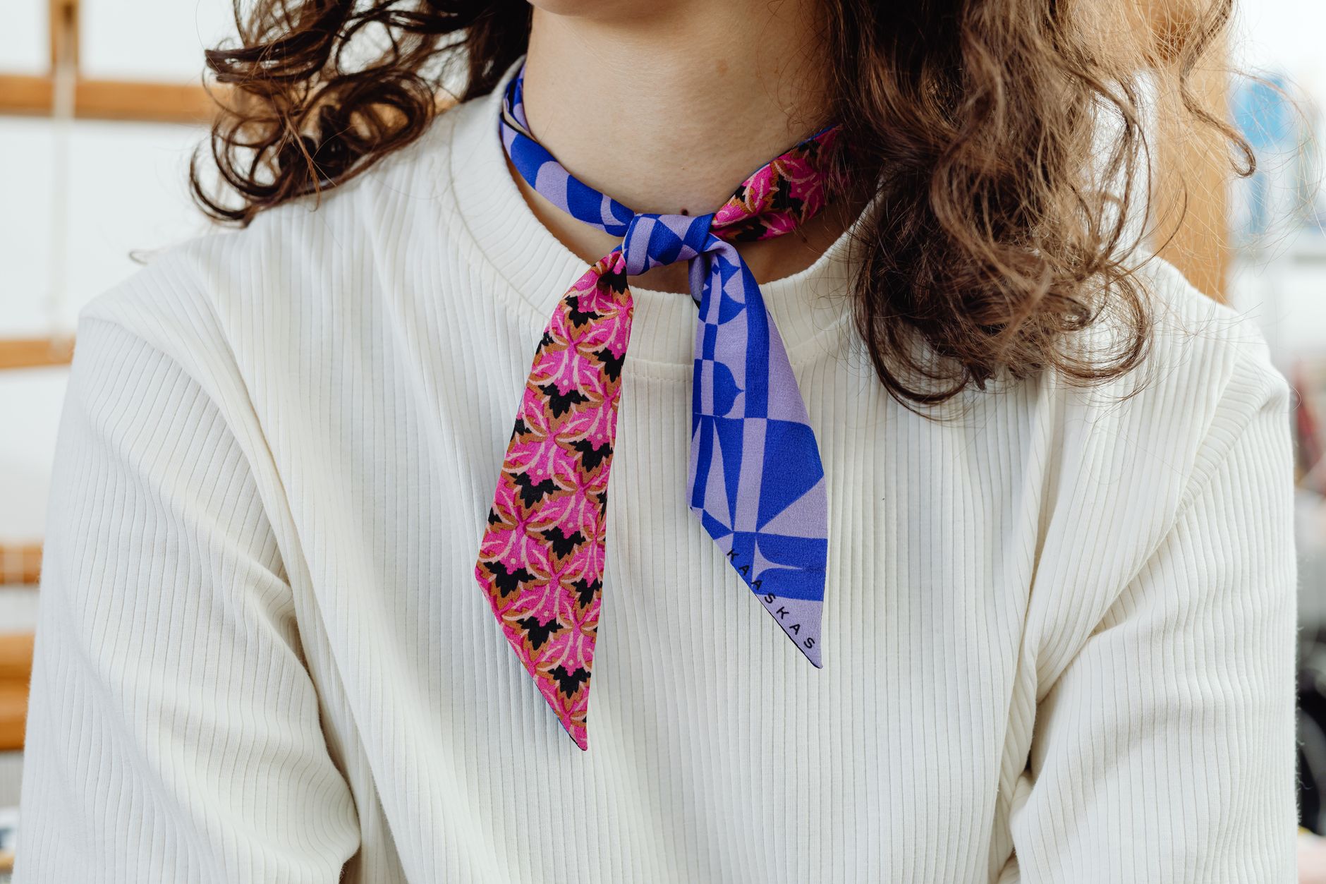 A sculptural standing collar styled as a statement fashion accessory