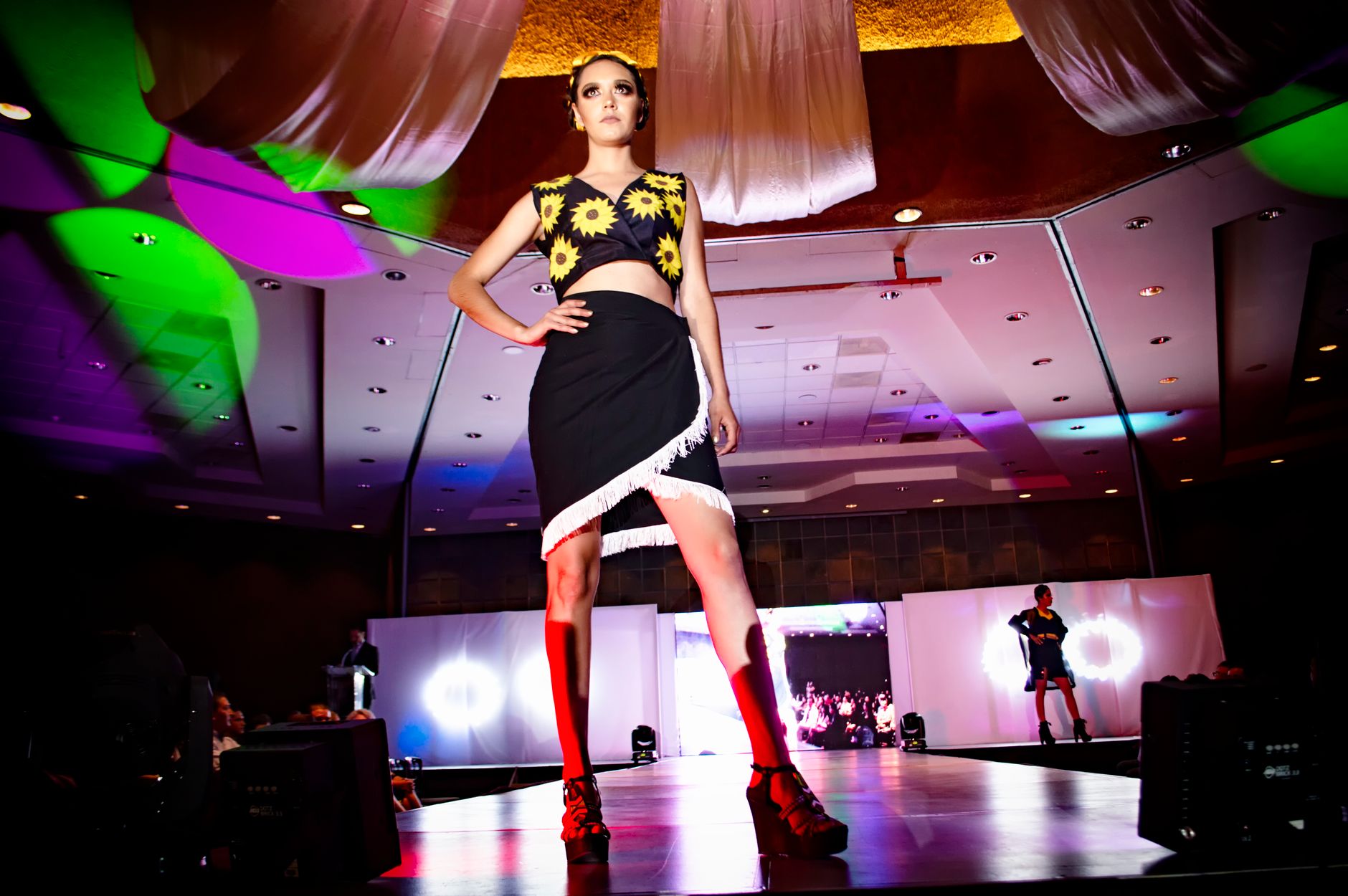Designer outerwear on runway showing armour-influenced silhouette and construction details