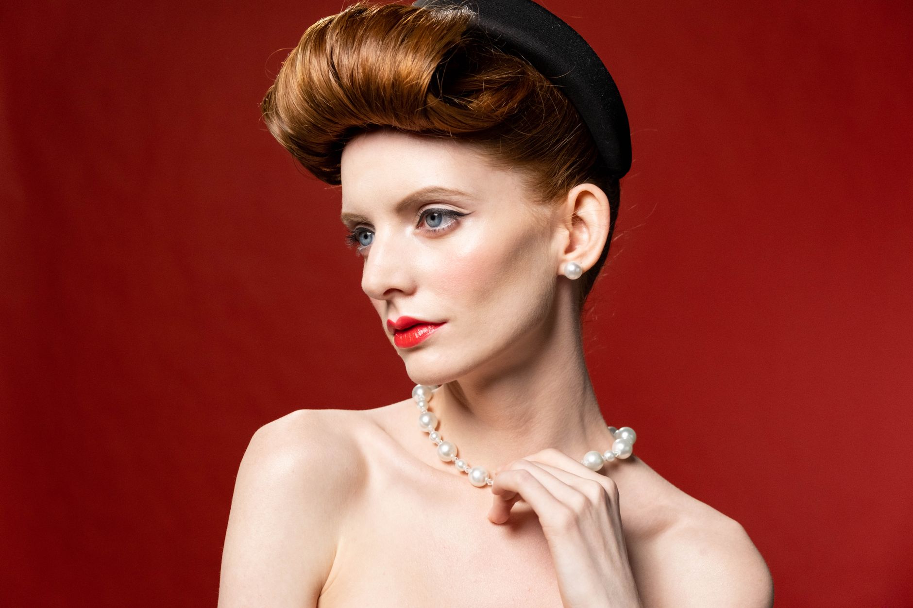 Editorial-style portrait featuring sculptural hair accessory woven into an elaborate braid at the crown