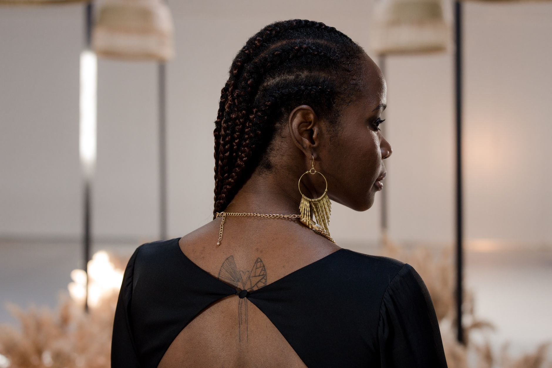 Detailed view of a structured braid hair piece with metal detailing inspired by equestrian grooming