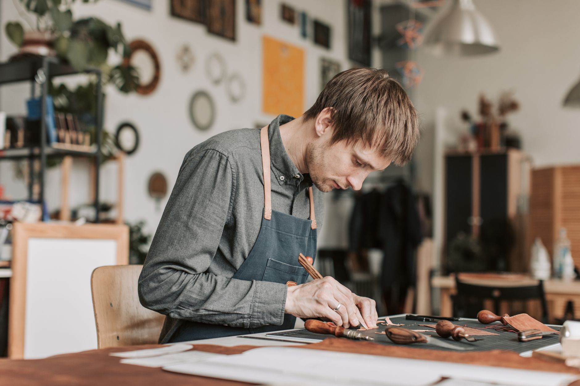 Artisan leather workshop with tools and hand-stitched accessories in progress