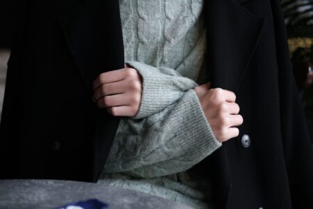 Polo Club Saddle Cloth Piping Is Quietly Trimming Tailored Outerwear Close-up of structured tailored coat with contrast trim detail along the front facing and collar edge