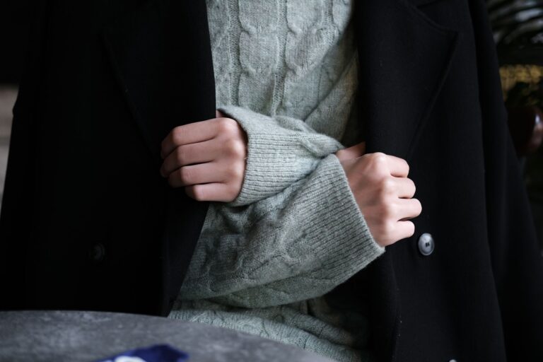 Polo Club Saddle Cloth Piping Is Quietly Trimming Tailored Outerwear Close-up of structured tailored coat with contrast trim detail along the front facing and collar edge