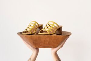 Close-up of structured high heel shoes with narrow tapered heel columns on a clean surface