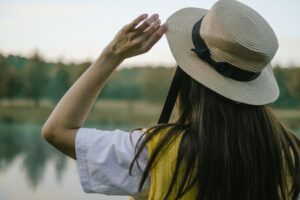 Close-up of a classic straw boater hat with grosgrain ribbon band in striped colors
