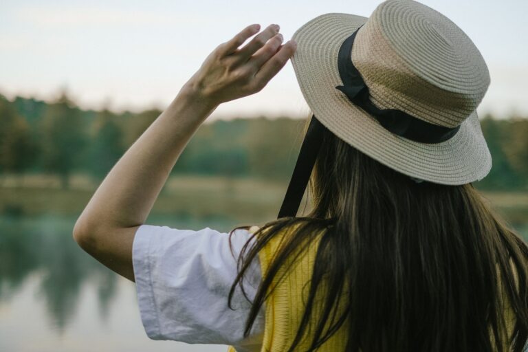 Close-up of a classic straw boater hat with grosgrain ribbon band in striped colors