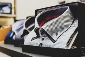 Close-up of a stiff formal shirt collar standing upright against a white background
