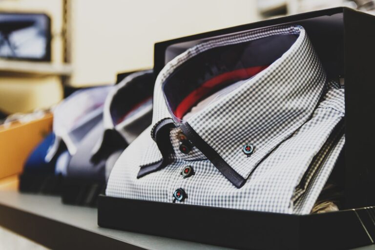 Close-up of a stiff formal shirt collar standing upright against a white background