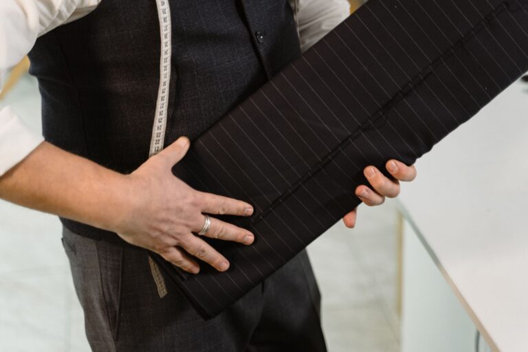 Close-up of structured tapered trouser hem in dark wool fabric