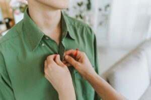 Close-up of a crisp white dress shirt collar with minimal hardware detail
