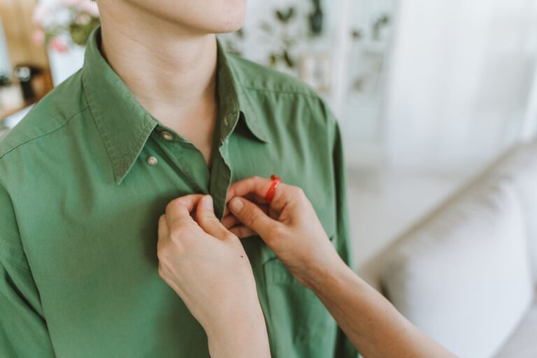 Close-up of a crisp white dress shirt collar with minimal hardware detail