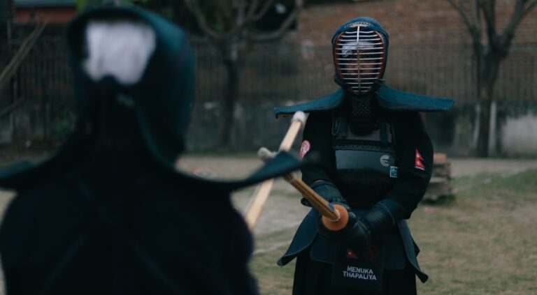 Close-up of traditional kendo do hip guard showing lacquered panels and vertical flap structure