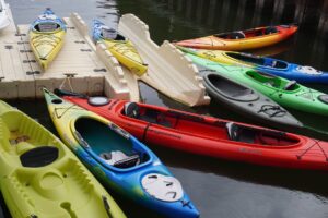 Close-up of bungee cord system stretched across a flat water kayak deck with metal fittings