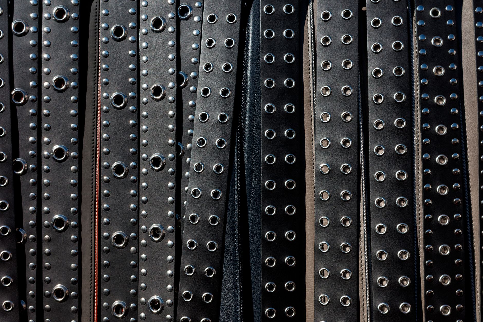 Close-up of a structured leather belt with antique metal buckle hardware