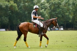Polo Club Suede Knee Patches Are Quietly Migrating Into Tailored Blazer Elbows Polo player on horseback wearing traditional white breeches with suede knee patches during a match