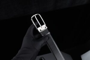 Polo Club Saddle Keeper Loops Are Quietly Buckling Into Bag Strap Hardware Close-up of leather strap with metal buckle hardware on a structured bag