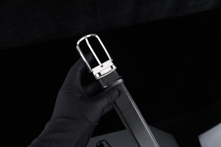 Polo Club Saddle Keeper Loops Are Quietly Buckling Into Bag Strap Hardware Close-up of leather strap with metal buckle hardware on a structured bag