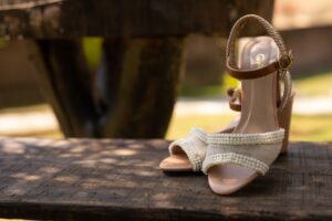 Polo Club Spur Straps Are Quietly Buckling Into Minimalist Ankle Bands Close-up of a narrow leather strap with a small roller buckle worn around a bare ankle
