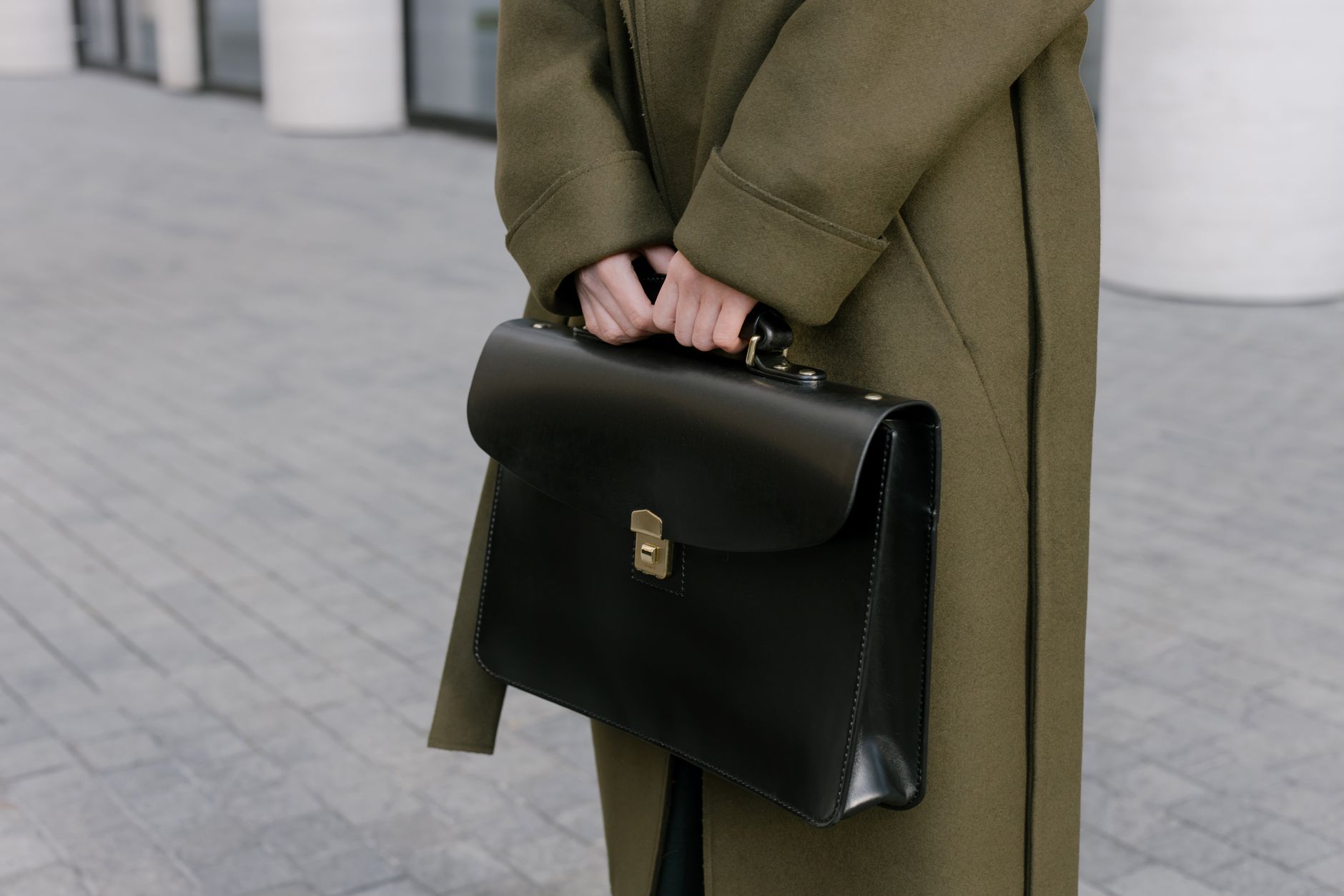 A structured minimalist leather tote bag photographed against a neutral background