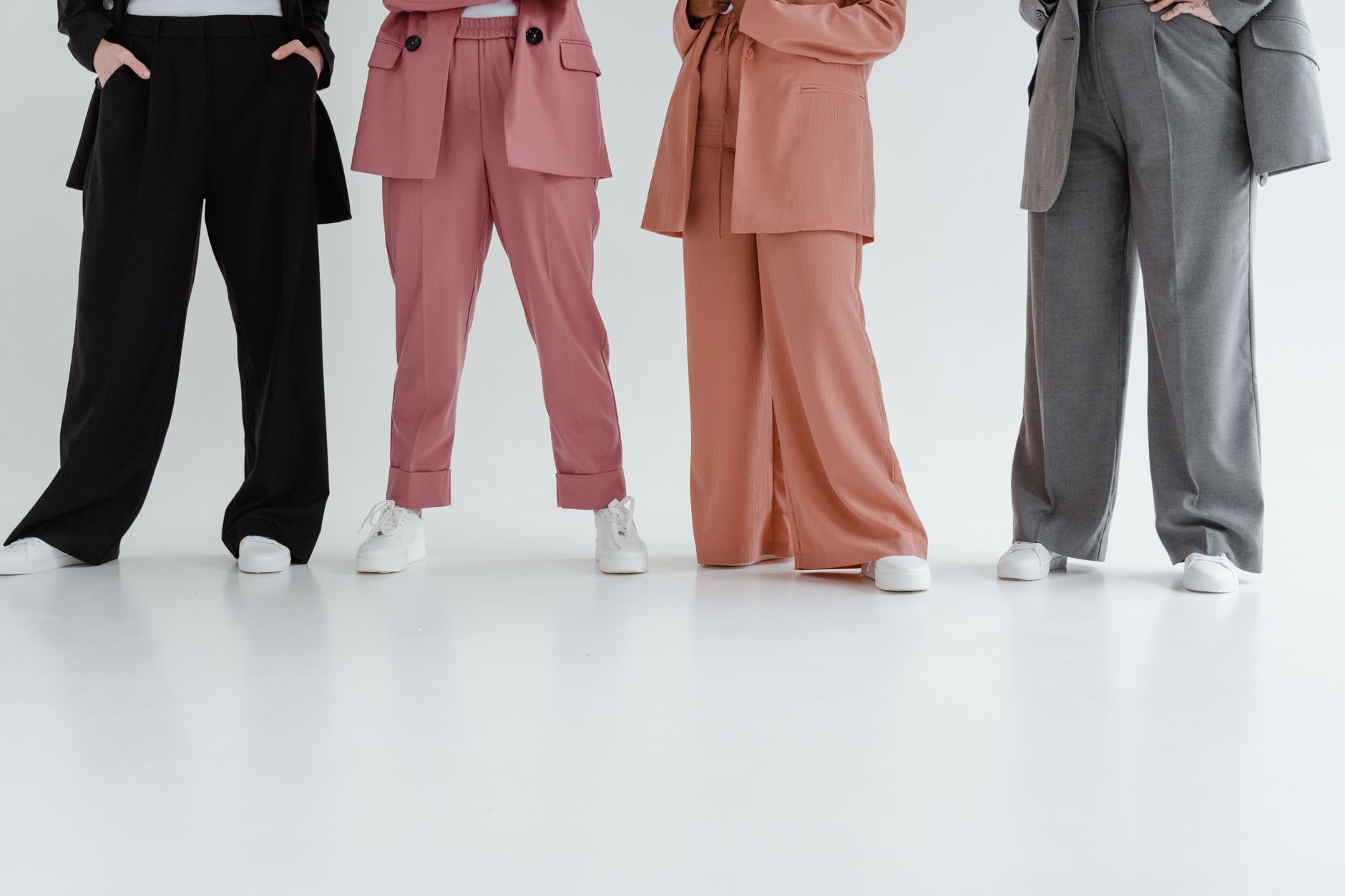 Detail shot of high-waisted tailored trousers with structured leather hardware at the thigh