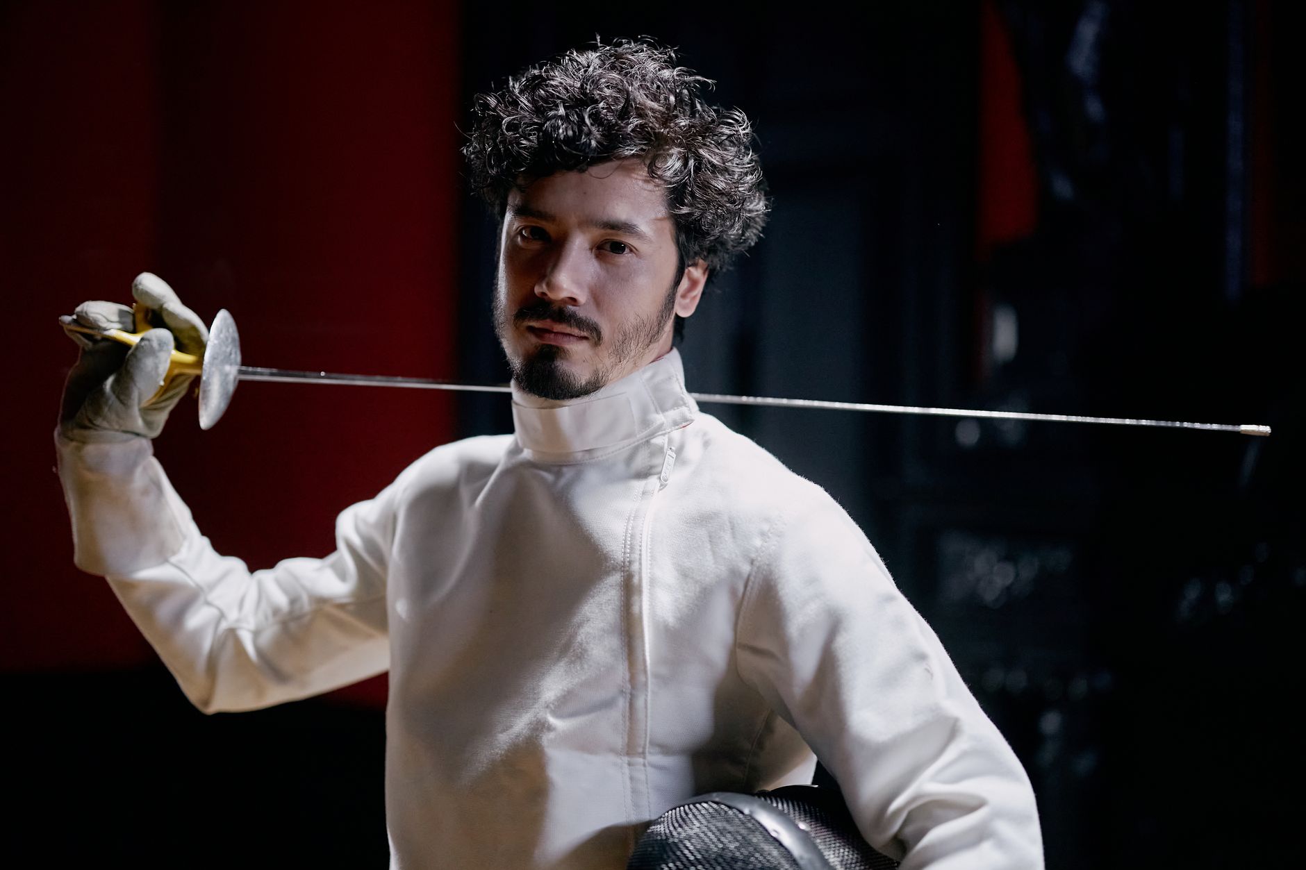 Detail of a fencing épée pistol grip showing ergonomic ridges and curved body