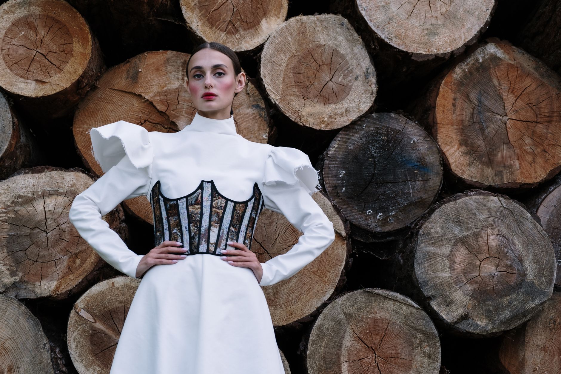 Fashion garment featuring asymmetric structured bodice with diagonal seaming detail