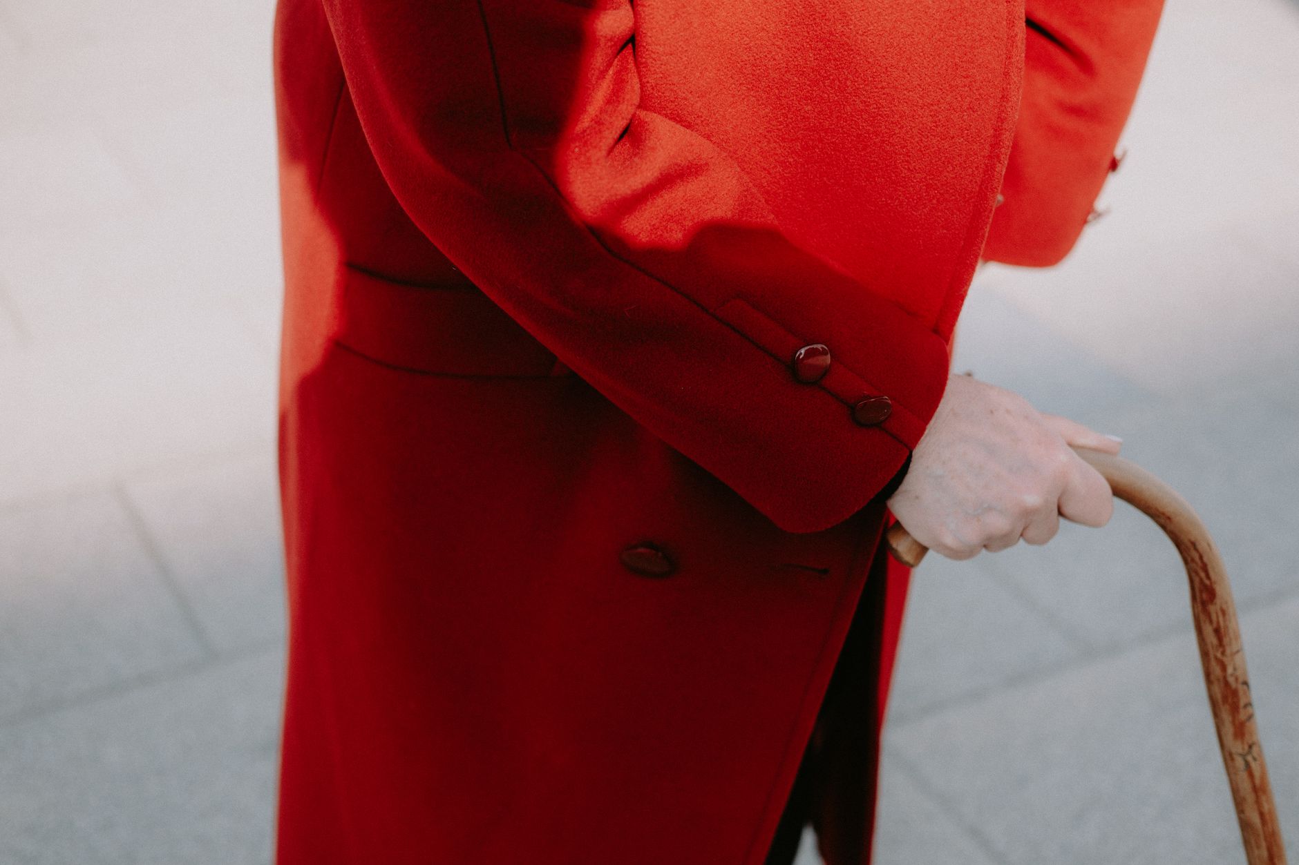 Detail shot of asymmetrical closure hardware on a structured fashion coat in heavy fabric