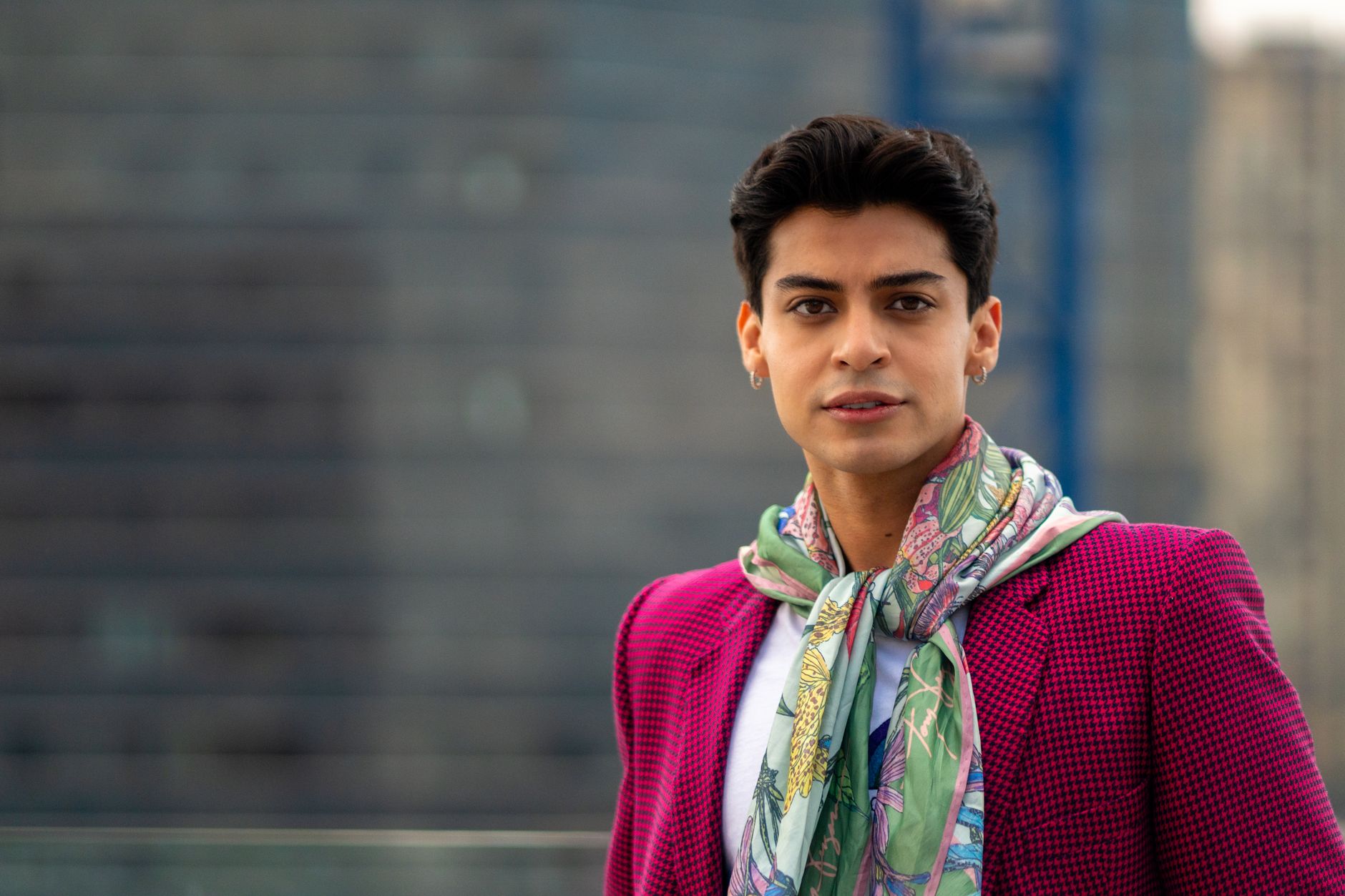Folded silk scarves displaying bold horizontal stripe patterns in navy, pale blue, and white tones
