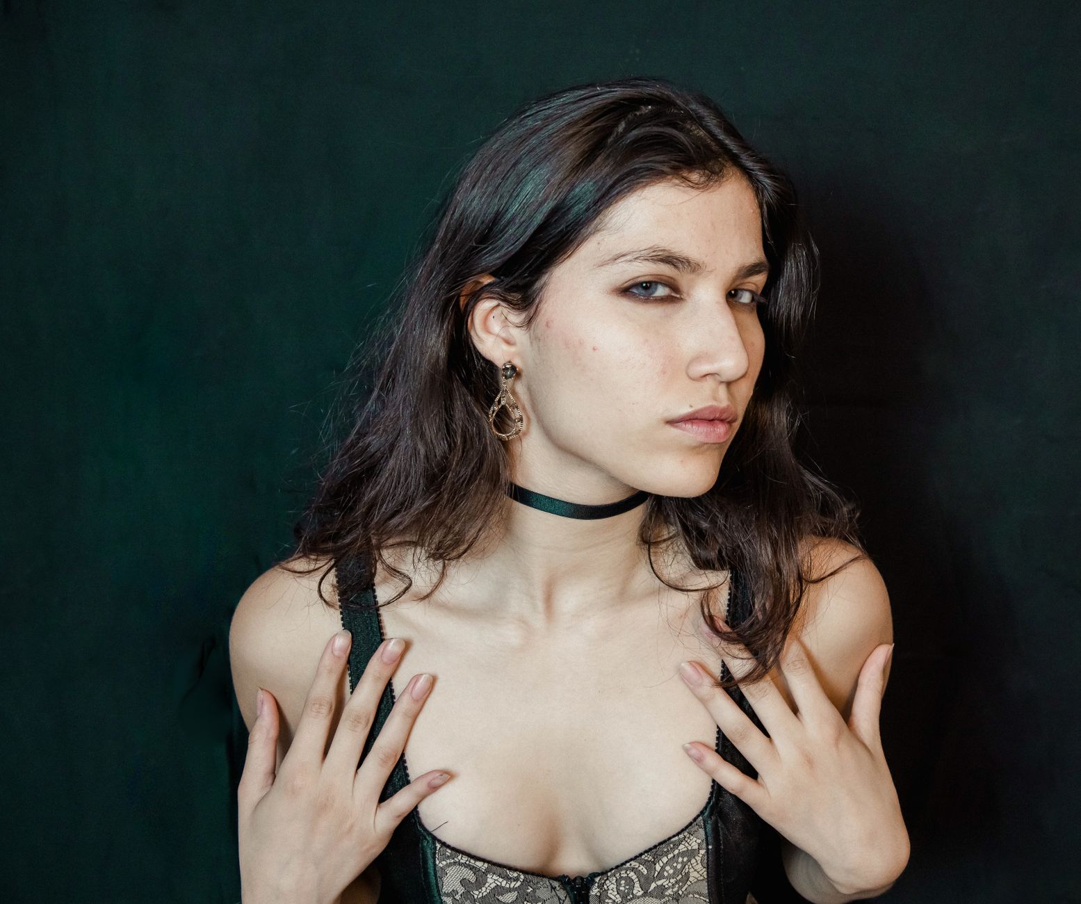 Layered oxidized metal choker with stacked horizontal bands styled against a neutral neckline