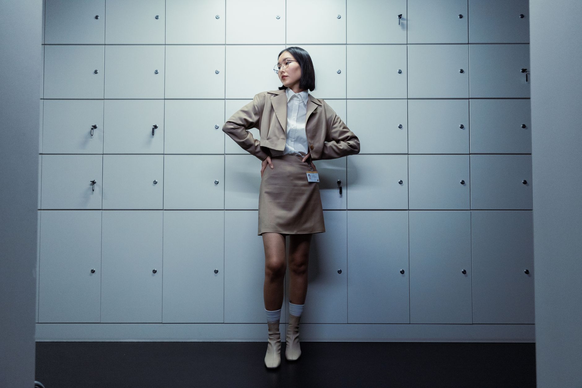 Model wearing a high-waisted structured skirt with visible paneled waistband construction