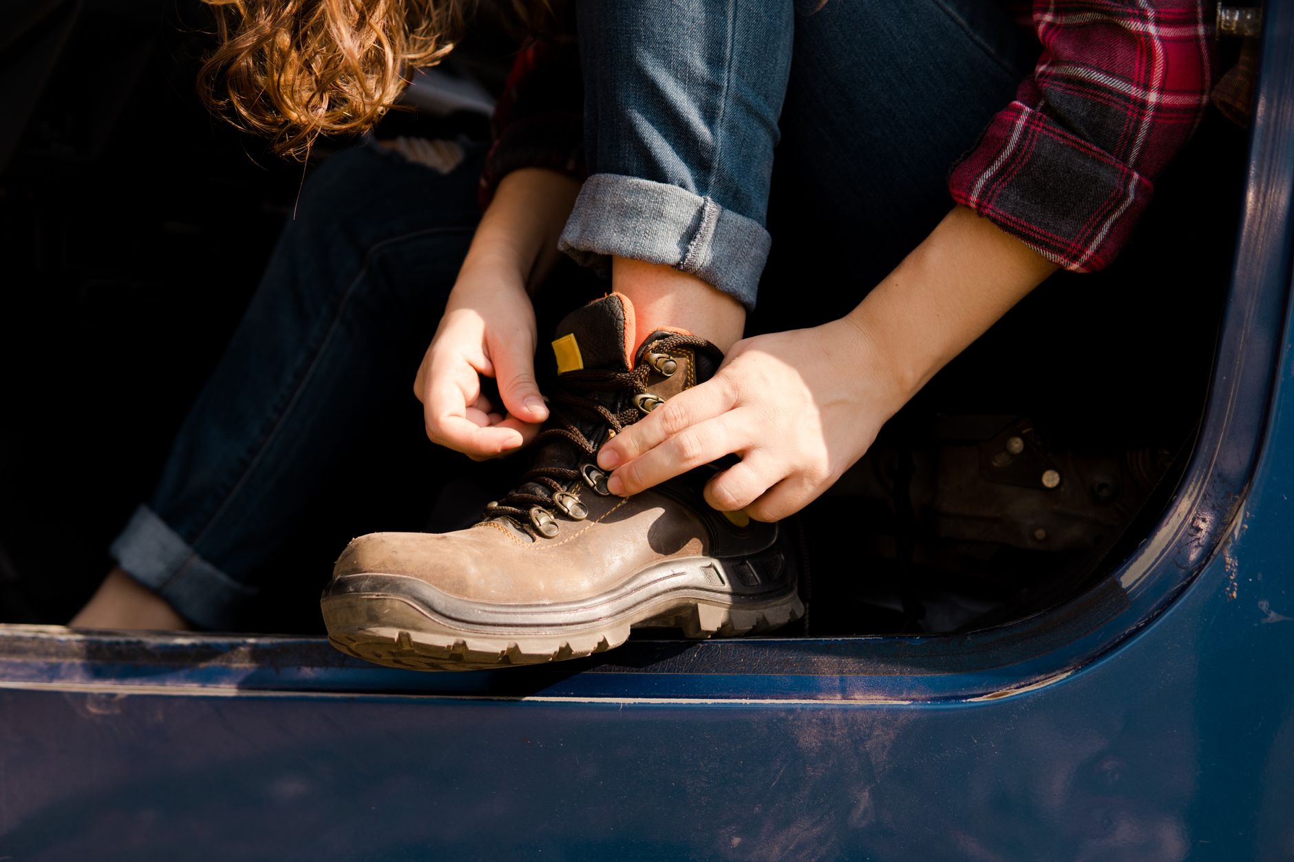 Detail shot of heavy-duty boots with technical hardware fastenings and cord closures