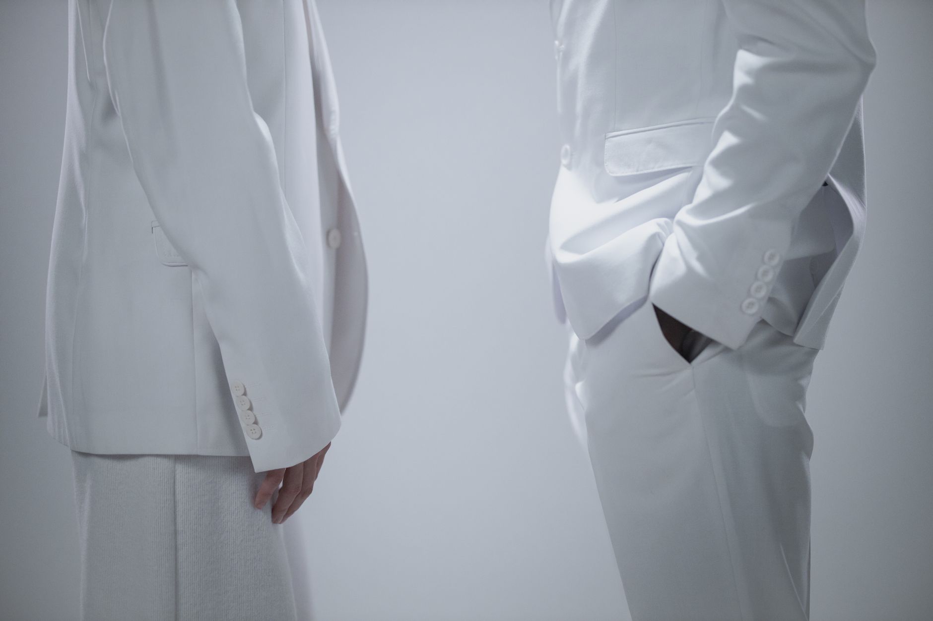 Detail shot of the back waistband and tab hardware on tailored dress trousers