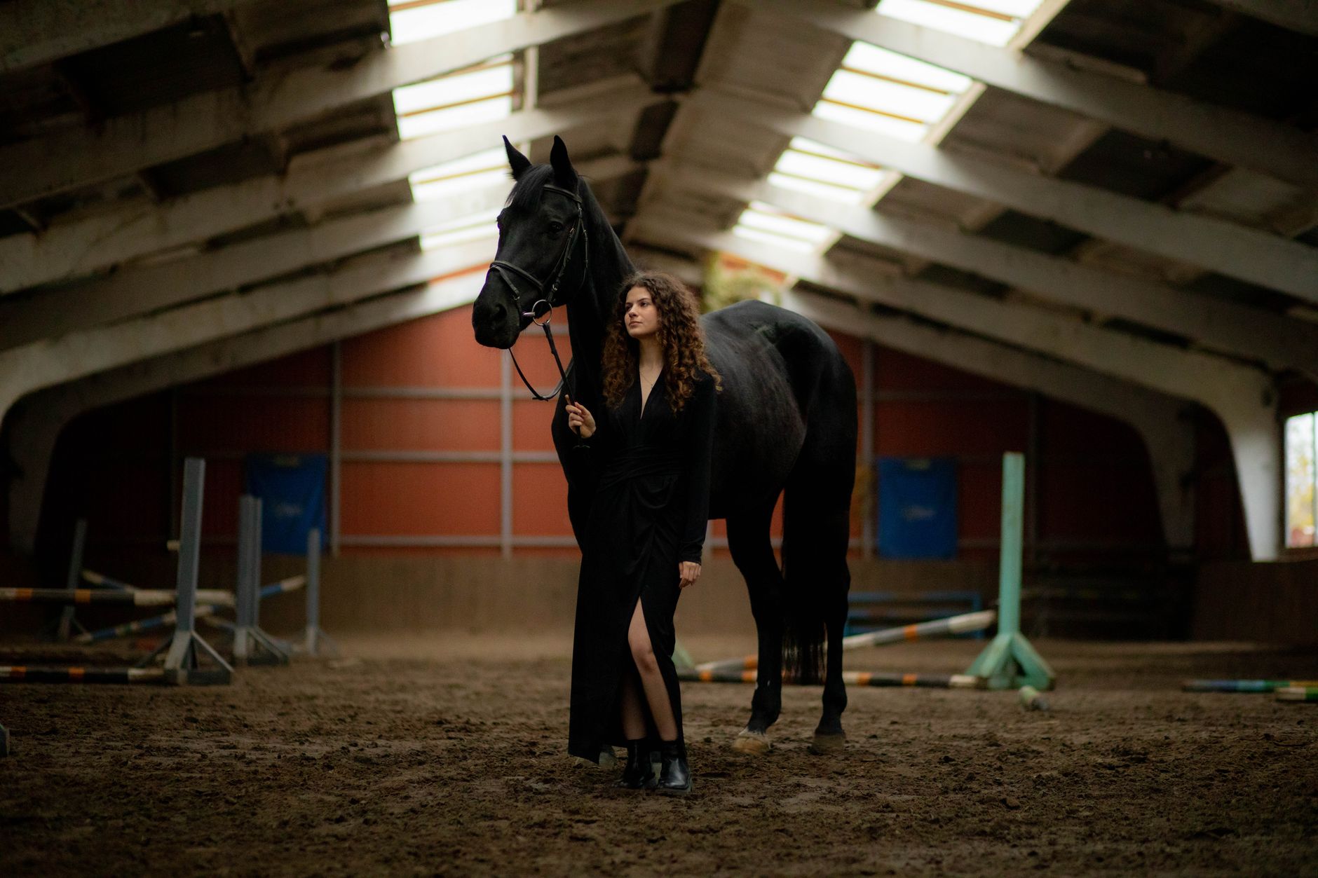Fashion editorial showing equestrian-inspired styling with tall riding boots and structured skirt
