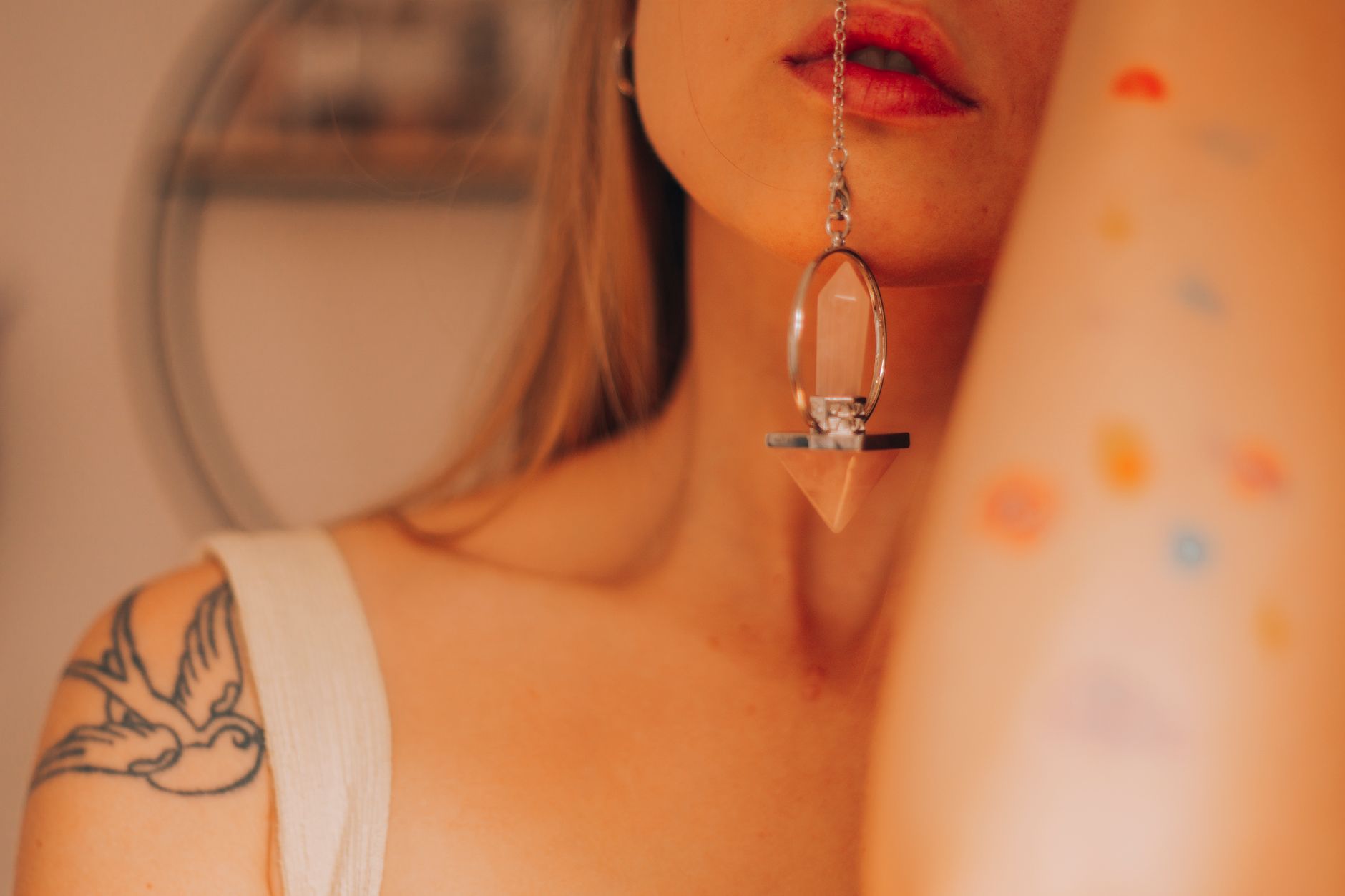 Model wearing layered metal body chain jewellery against bare skin