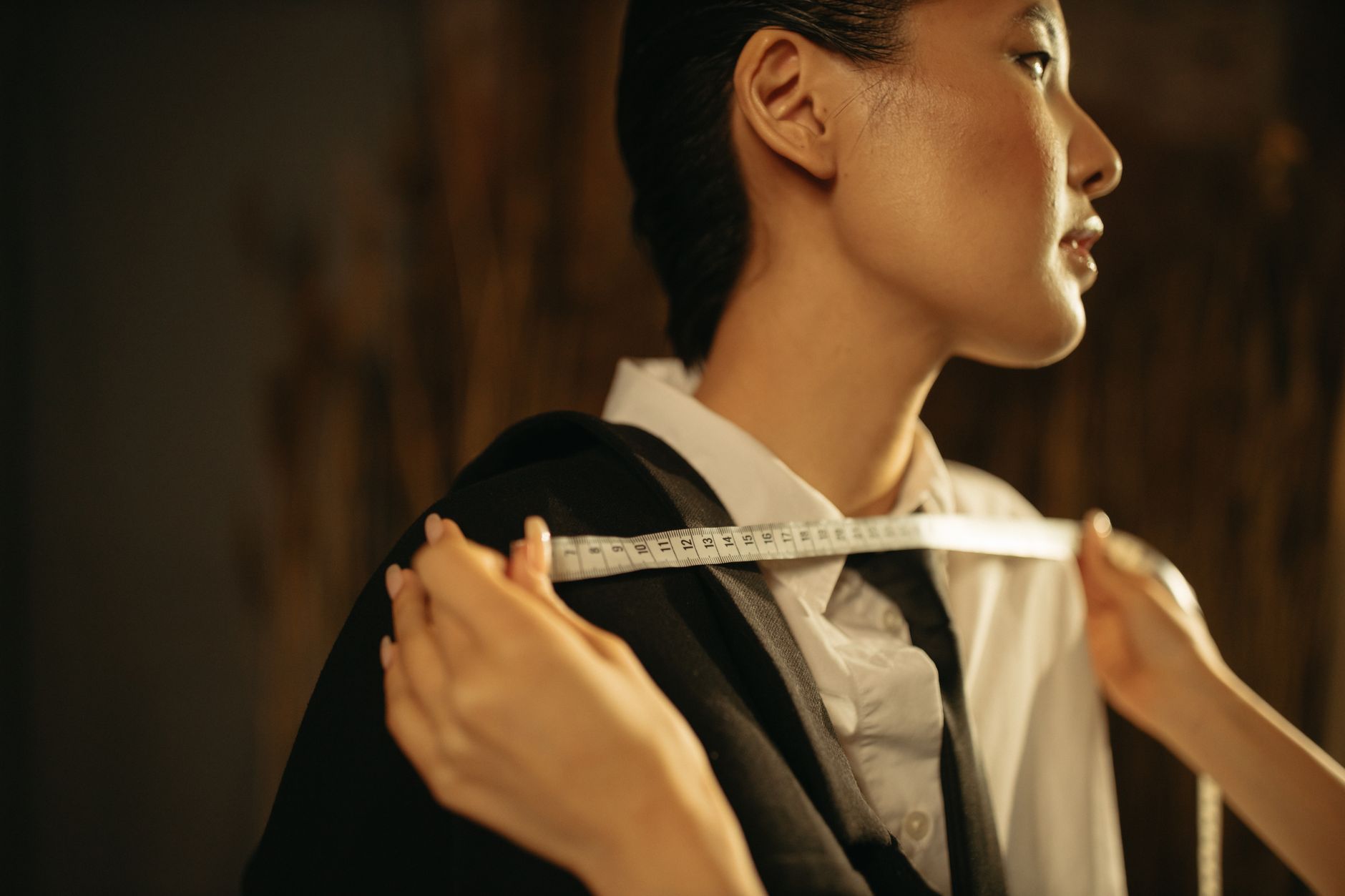 Model wearing structured tailored suit with architectural bodice paneling