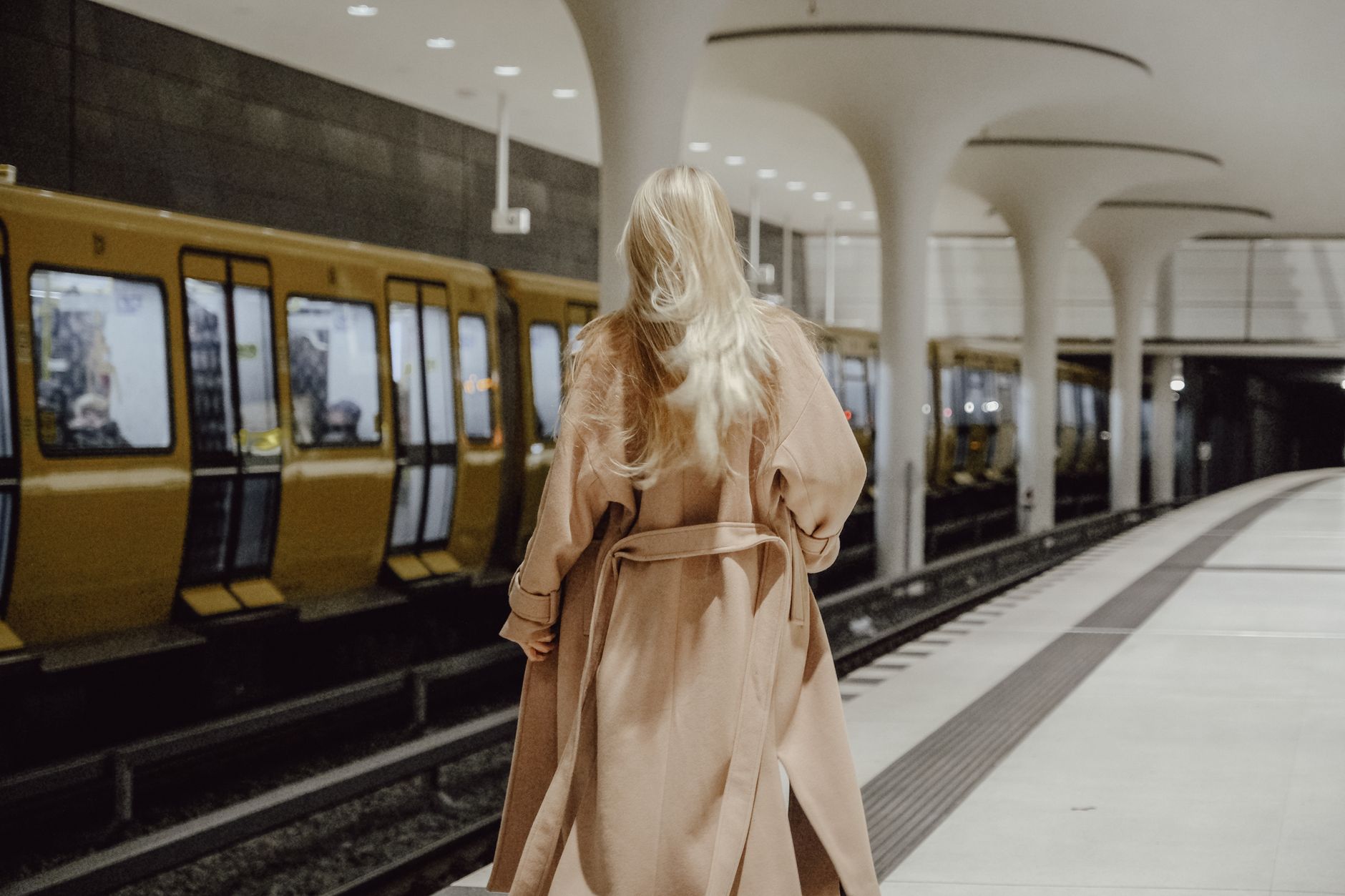 Model wearing an avant-garde structured coat with industrial hardware closures on the front panel