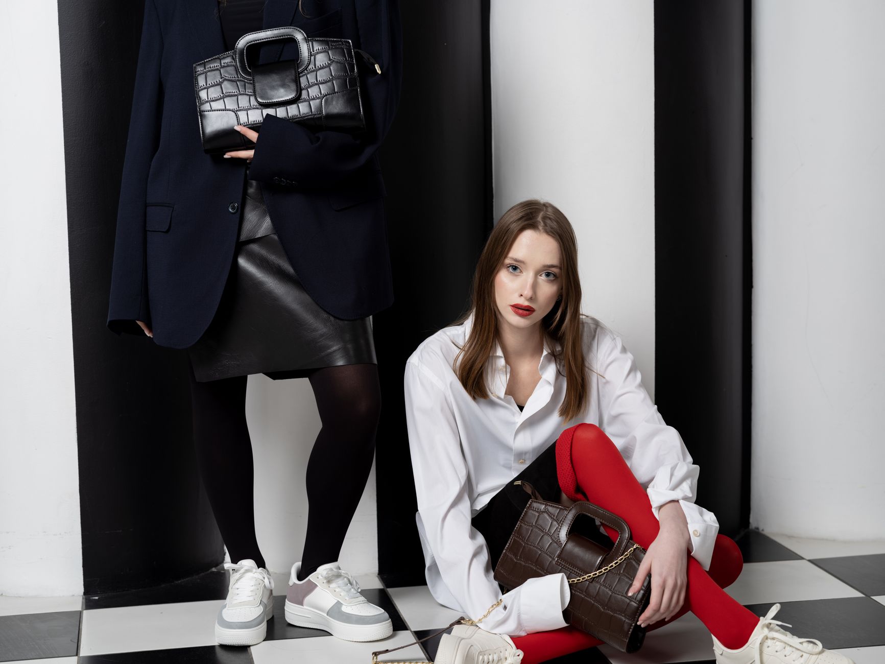 Structured navy leather accessories including a card holder and belt with contrast white stitching detail