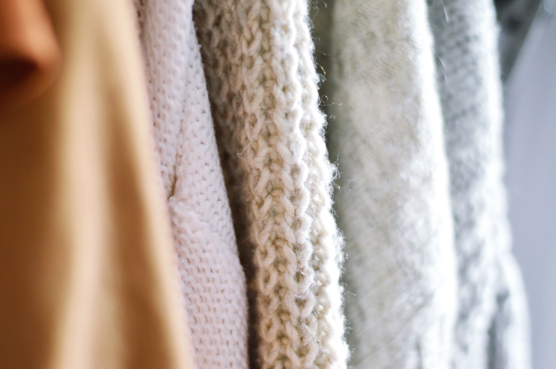 Neatly folded high-contrast knit sweater with geometric panel detailing in dark and light tones