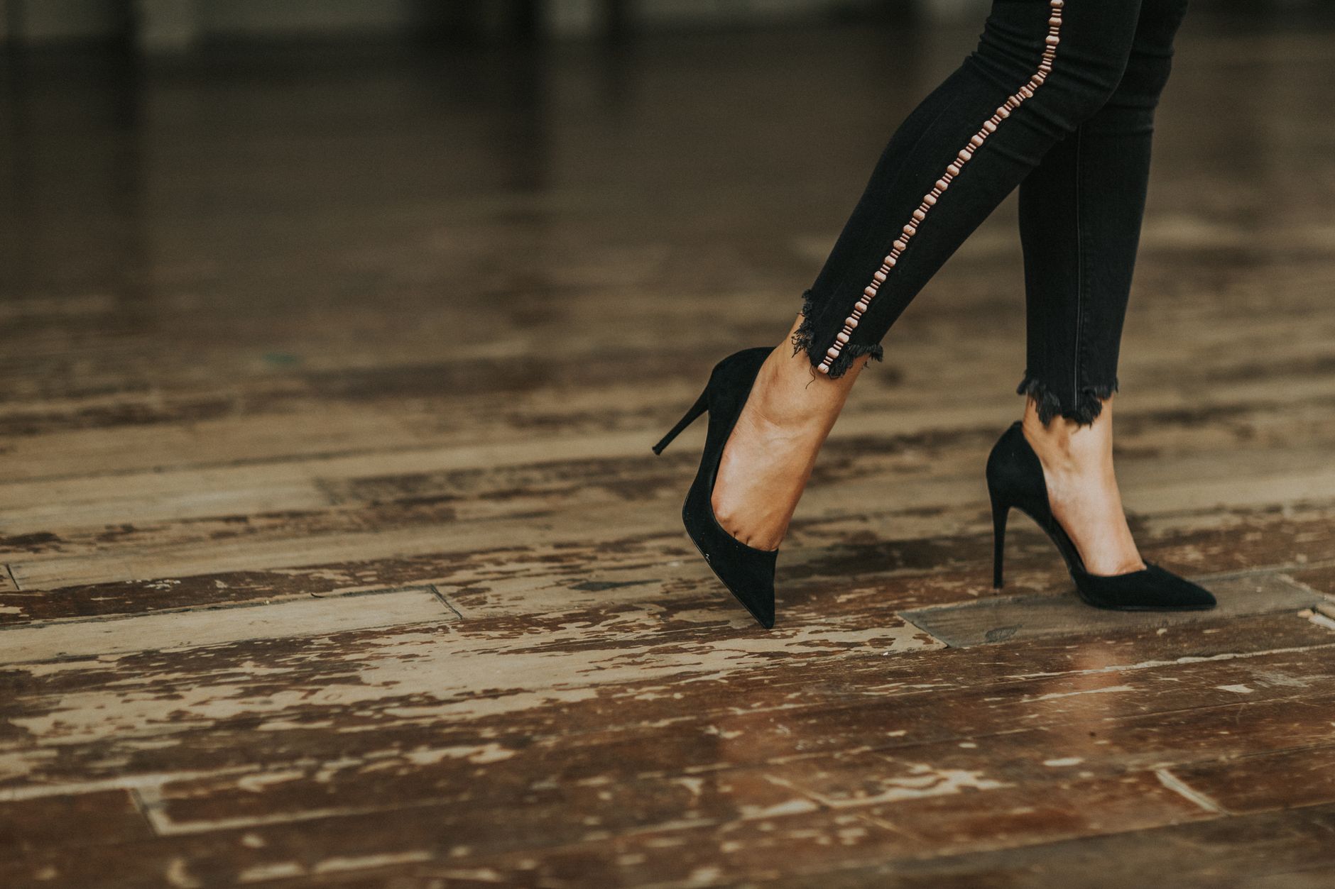 Model wearing statement heels on a runway showing structured silhouette from ankle to floor