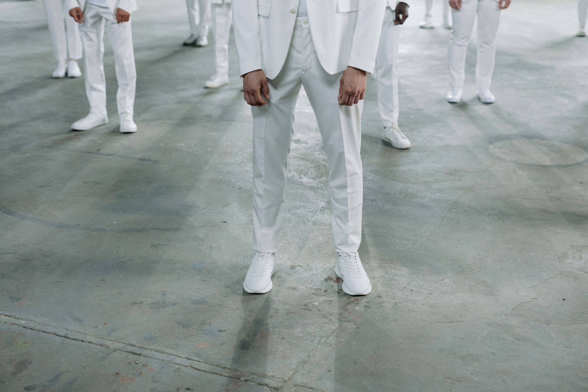 Model wearing structured formal menswear on a fashion runway