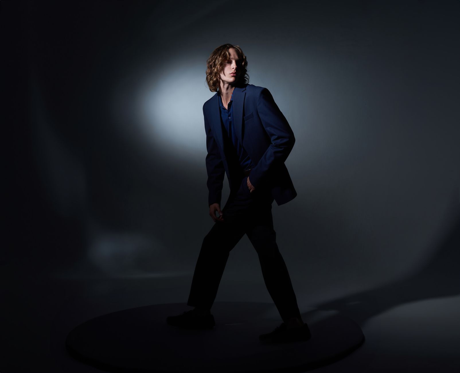 Menswear editorial showing structured jacket silhouette with split hem detail