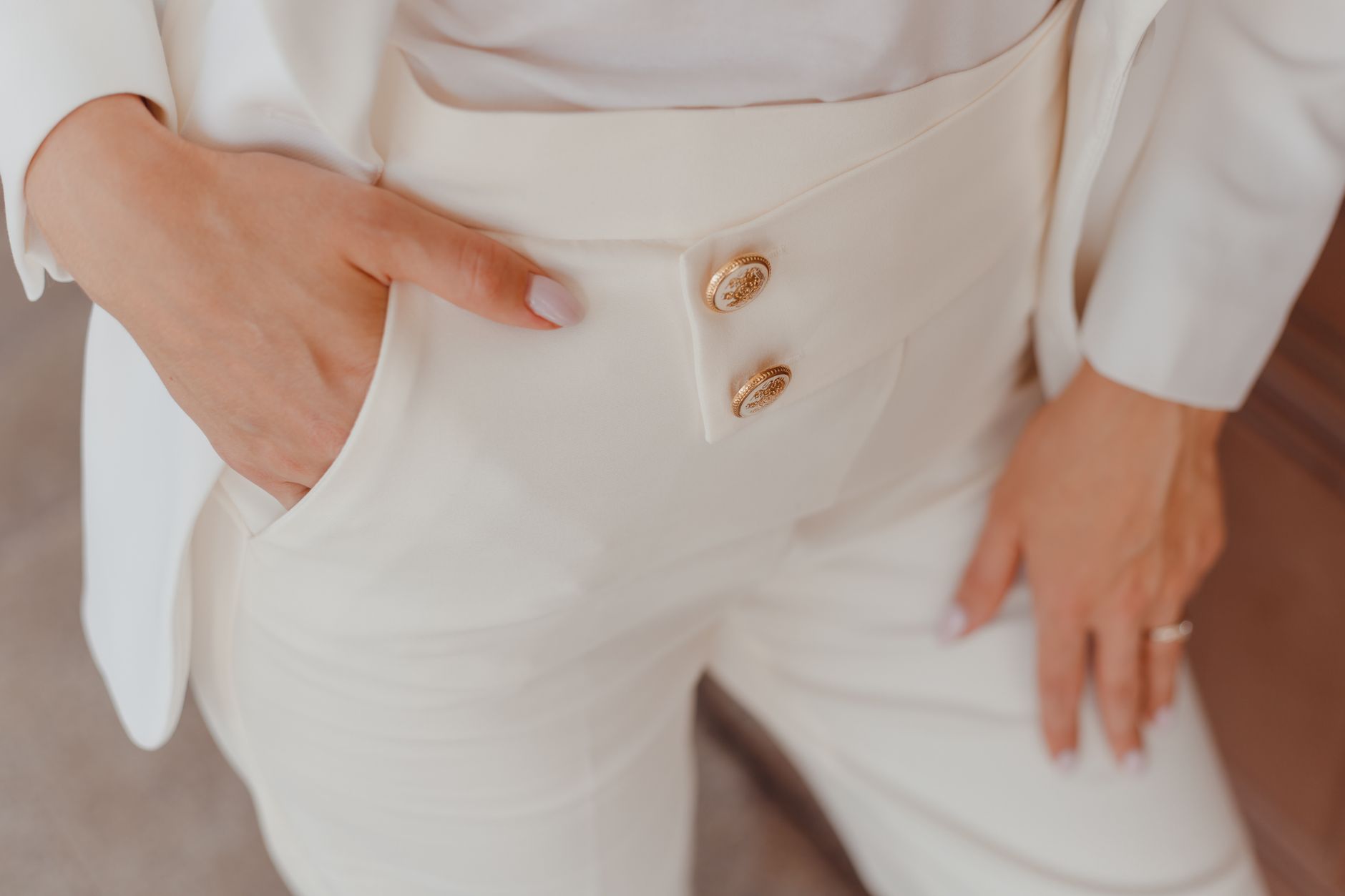 Minimalist fashion accessory detail on the lower leg, narrow band against a neutral outfit