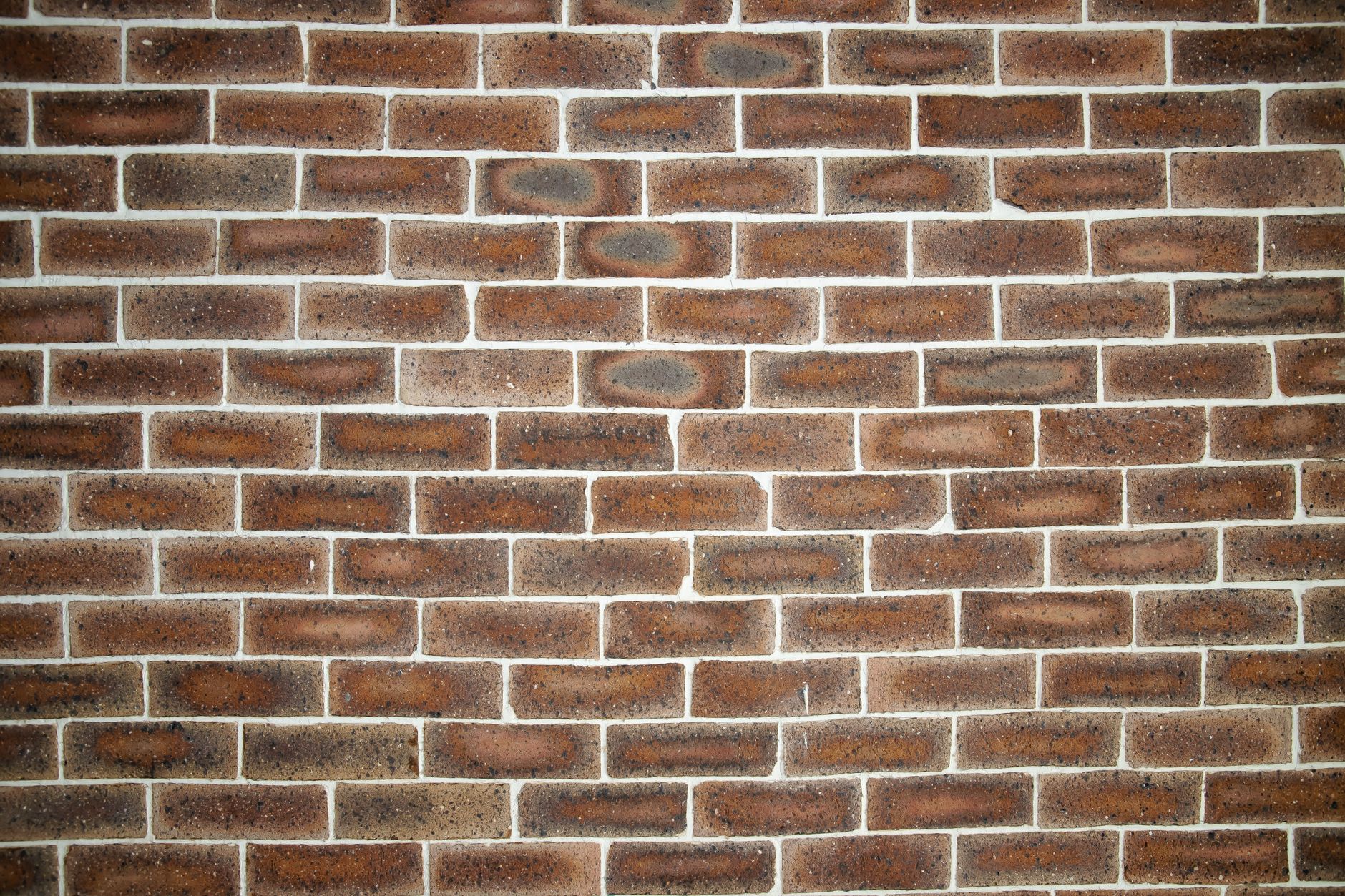 Weathered brick wall surface showing aged red and orange tones