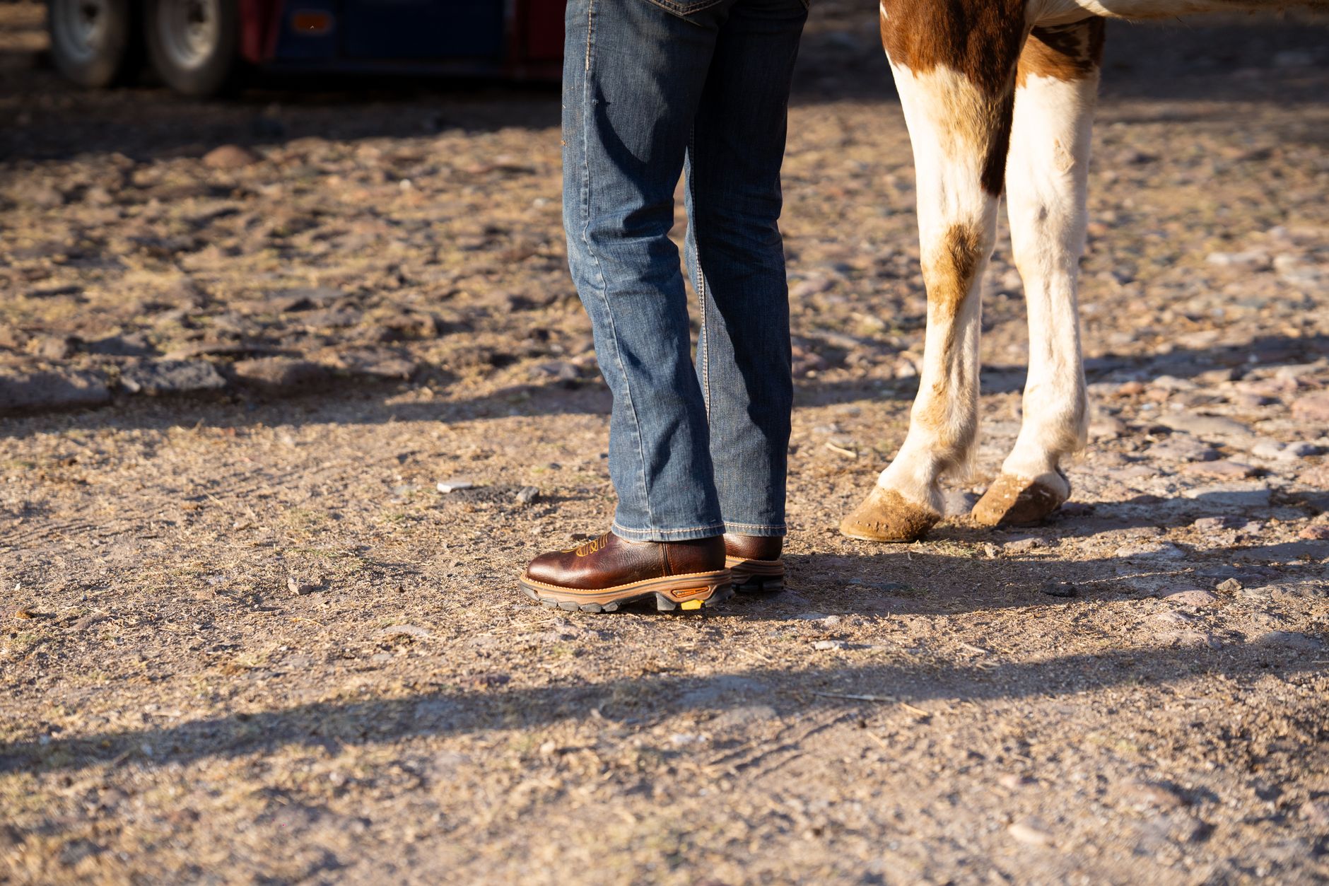 Workwear-styled boots worn with heavy canvas trousers in an outdoor urban setting